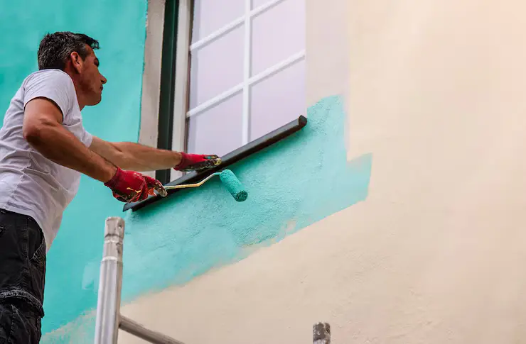 worker-paints-facade-walls-house-with-paint-using-paint-roller_1086986-202 exterior painters